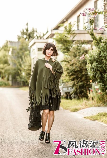 5 Tian Yuan wearing the Burberry fringed cashmere poncho while carrying th...